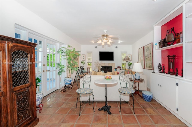 8445 SW 80th Pl, Miami, FL 33143 - living area with a fireplace, ceiling fan, and tile patterned floors