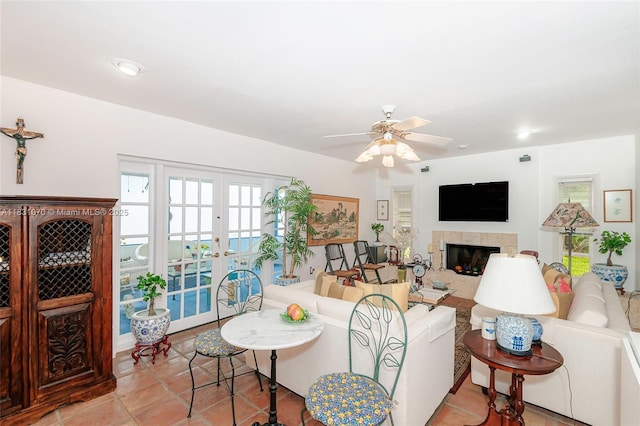8445 SW 80th Pl, Miami, FL 33143 - living area with french doors, a ceiling fan, and a fireplace