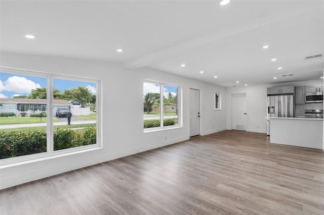 6117 NW 9th St, Margate, FL 33063 - unfurnished living room featuring recessed lighting, light wood-style flooring, and beam ceiling