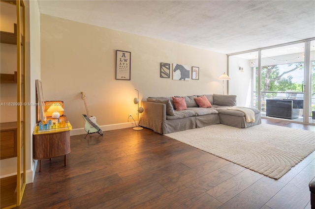 living area with hardwood / wood-style flooring and expansive windows