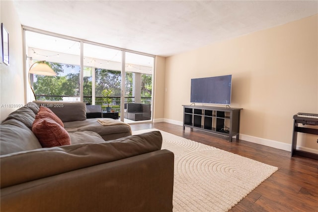 living room with wood finished floors and a wall of windows