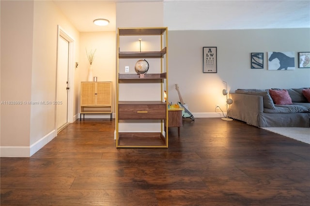 living room with dark wood-style flooring and baseboards