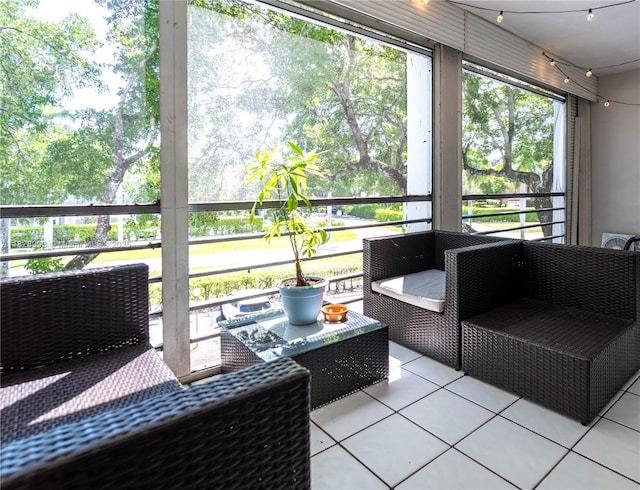 sunroom / solarium featuring an outdoor living space and healthy amount of natural light