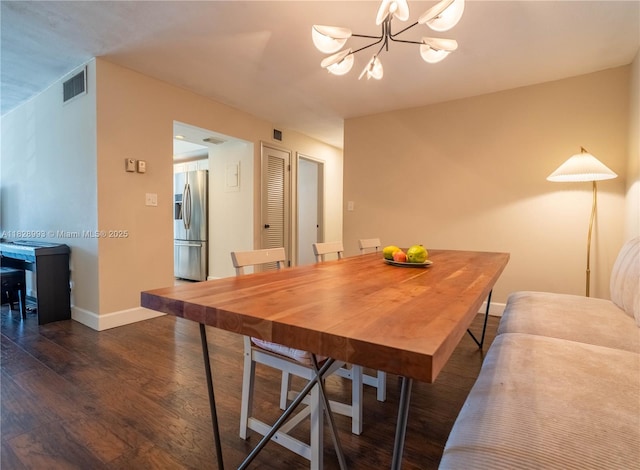 dining area with dark wood-style floors and a chandelier