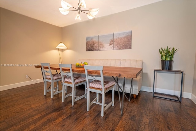 dining space with breakfast area, a chandelier, and wood finished floors