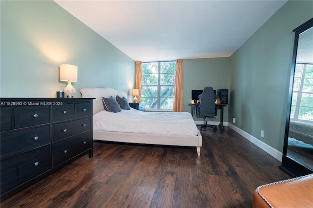 bedroom with wood finished floors and vaulted ceiling
