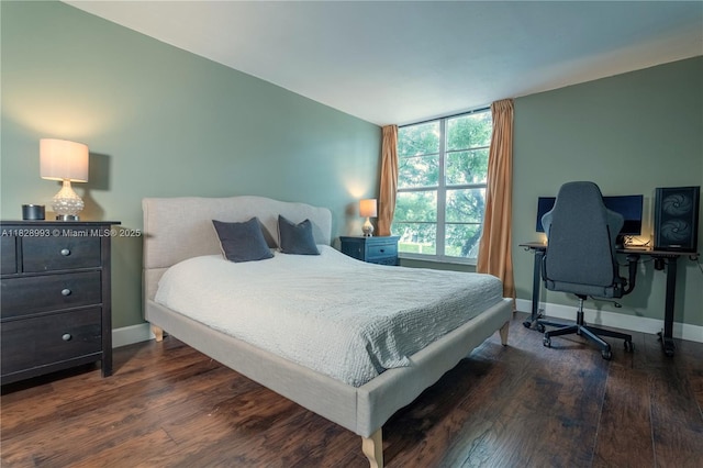 bedroom with wood finished floors and baseboards