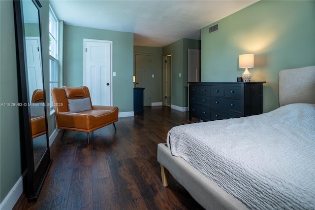 bedroom with wood finished floors and baseboards