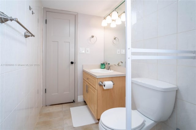 bathroom featuring vanity, tile walls, and tile patterned flooring
