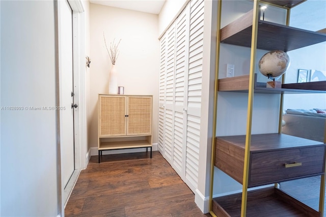 hall with dark wood finished floors and baseboards