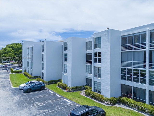 view of property featuring uncovered parking