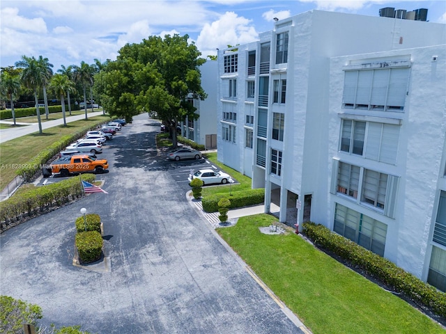 view of community featuring uncovered parking