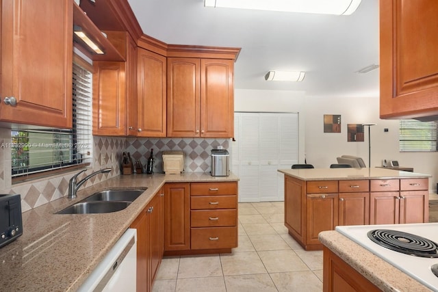 15471 SW 83rd Ave, Palmetto Bay, FL 33157 - kitchen featuring dishwasher, backsplash, light stone counters, brown cabinets, and light tile patterned floors