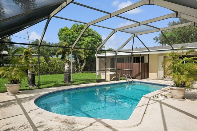 15471 SW 83rd Ave, Palmetto Bay, FL 33157 - swimming pool with a lawn, a patio, and a lanai