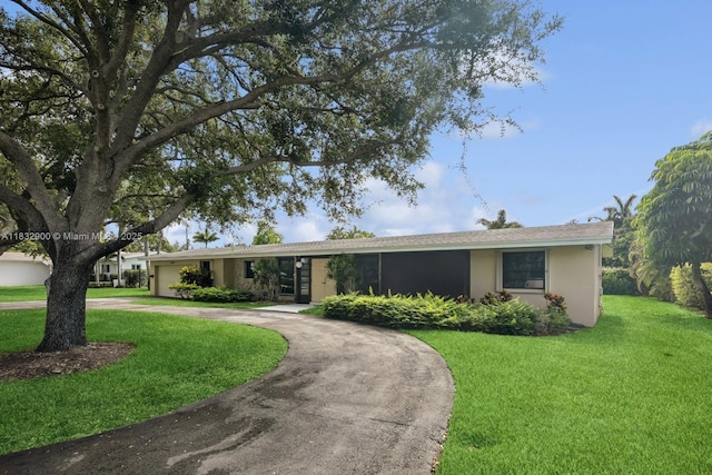 15471 SW 83rd Ave, Palmetto Bay, FL 33157 - single story home with curved driveway, a front yard, stucco siding, and a garage