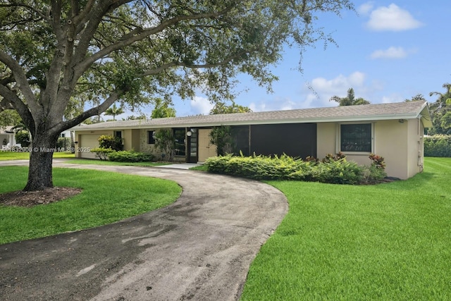15471 SW 83rd Ave, Palmetto Bay, FL 33157 - single story home featuring curved driveway, stucco siding, a front yard, and a garage