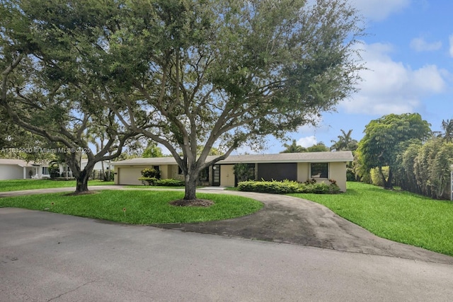 15471 SW 83rd Ave, Palmetto Bay, FL 33157 - ranch-style home featuring curved driveway, a front yard, stucco siding, and an attached garage