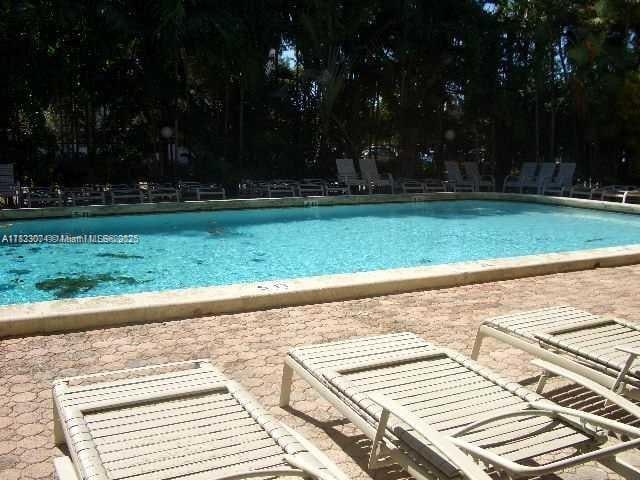 3703 NE 166th St Unit 905, North Miami Beach, FL 33160 - community pool featuring a patio area