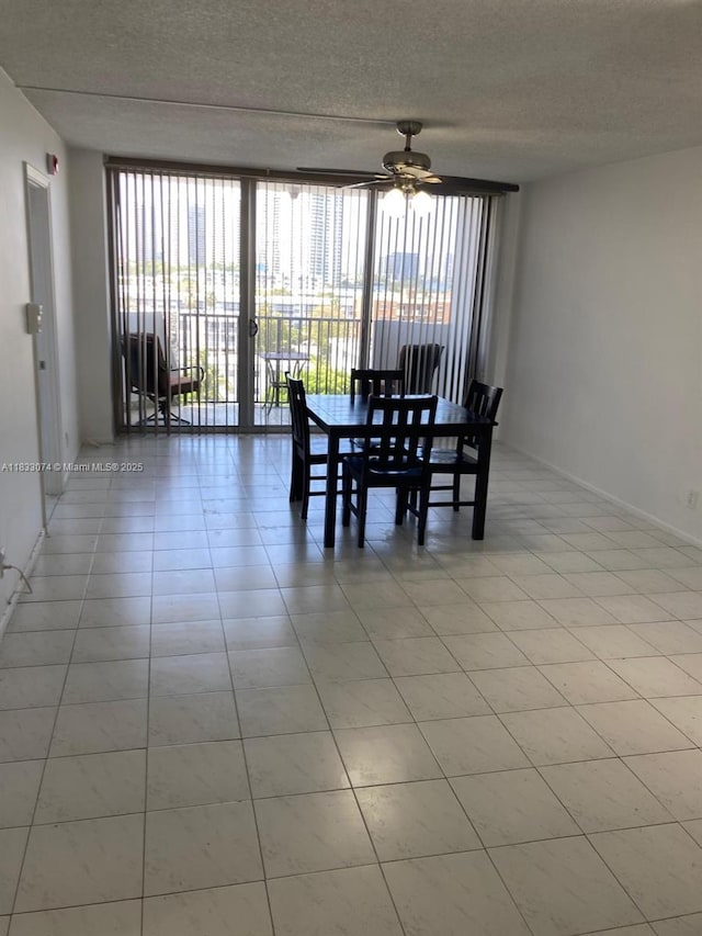 3703 NE 166th St Unit 905, North Miami Beach, FL 33160 - dining space with plenty of natural light, ceiling fan, expansive windows, and a textured ceiling