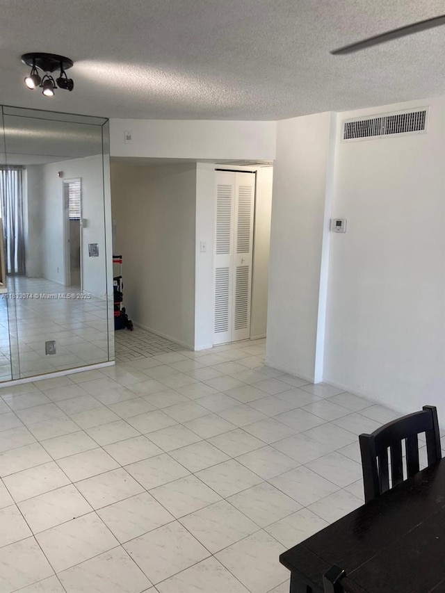 3703 NE 166th St Unit 905, North Miami Beach, FL 33160 - empty room with a textured ceiling and light tile patterned flooring