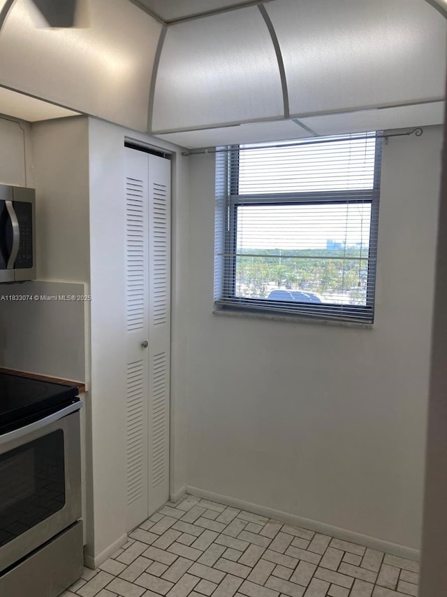 3703 NE 166th St Unit 905, North Miami Beach, FL 33160 - kitchen with stainless steel appliances and brick patterned flooring
