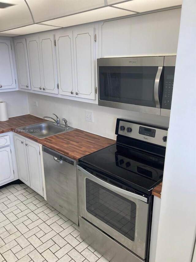 3703 NE 166th St Unit 905, North Miami Beach, FL 33160 - kitchen featuring appliances with stainless steel finishes, butcher block counters, and white cabinets