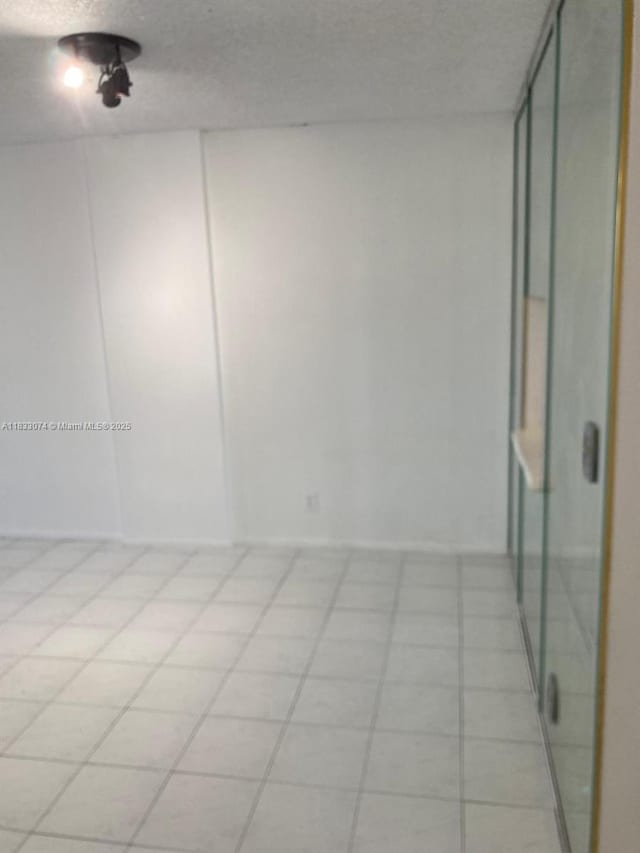 3703 NE 166th St Unit 905, North Miami Beach, FL 33160 - empty room featuring light tile patterned floors