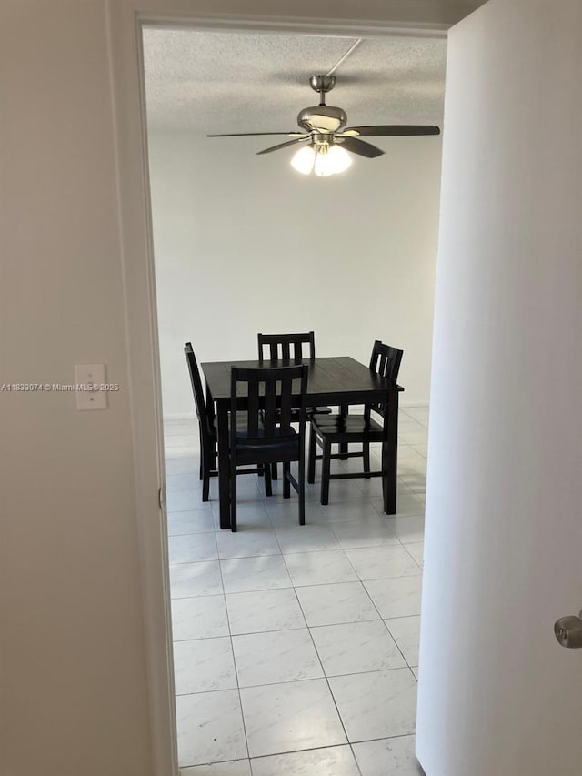 3703 NE 166th St Unit 905, North Miami Beach, FL 33160 - dining room featuring light tile patterned flooring, ceiling fan, and a textured ceiling
