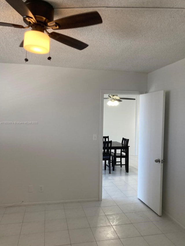 3703 NE 166th St Unit 905, North Miami Beach, FL 33160 - empty room with ceiling fan, light tile patterned flooring, and a textured ceiling