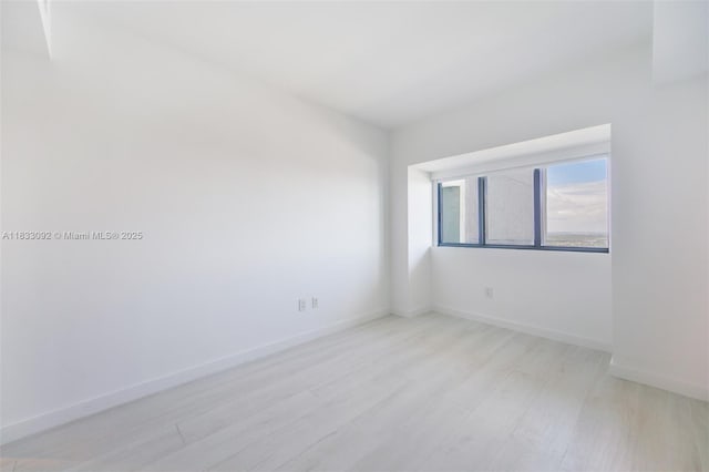 650 NE 32nd St Unit 4301, Miami, FL 33137 - spare room featuring light wood-style flooring and baseboards