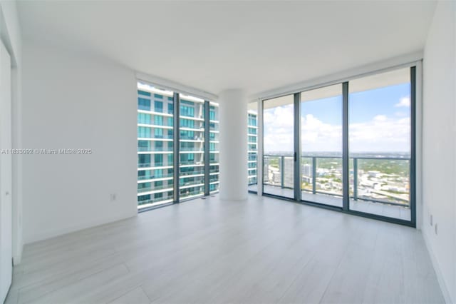 650 NE 32nd St Unit 4301, Miami, FL 33137 - spare room featuring floor to ceiling windows and wood finished floors