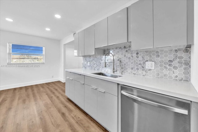 1200 SW 130th Ave Unit 412G, Pembroke Pines, FL 33027 - kitchen with dishwasher, light countertops, light wood finished floors, decorative backsplash, and recessed lighting