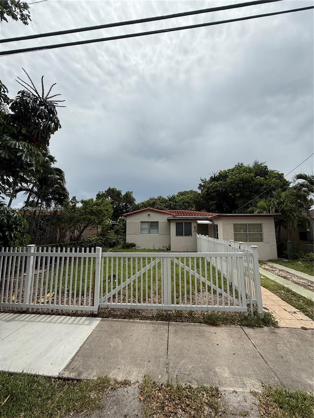 110 SW 64th Ct, Miami, FL 33144 - view of front facade featuring a fenced front yard and stucco siding