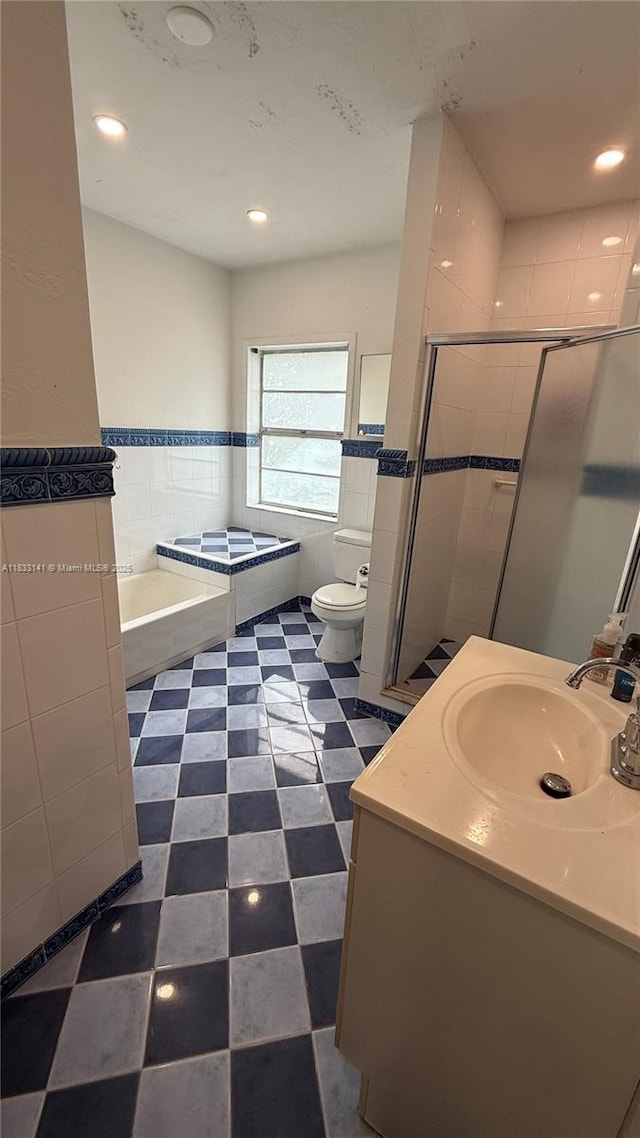 110 SW 64th Ct, Miami, FL 33144 - full bathroom with tile walls, a garden tub, vanity, a shower stall, and recessed lighting