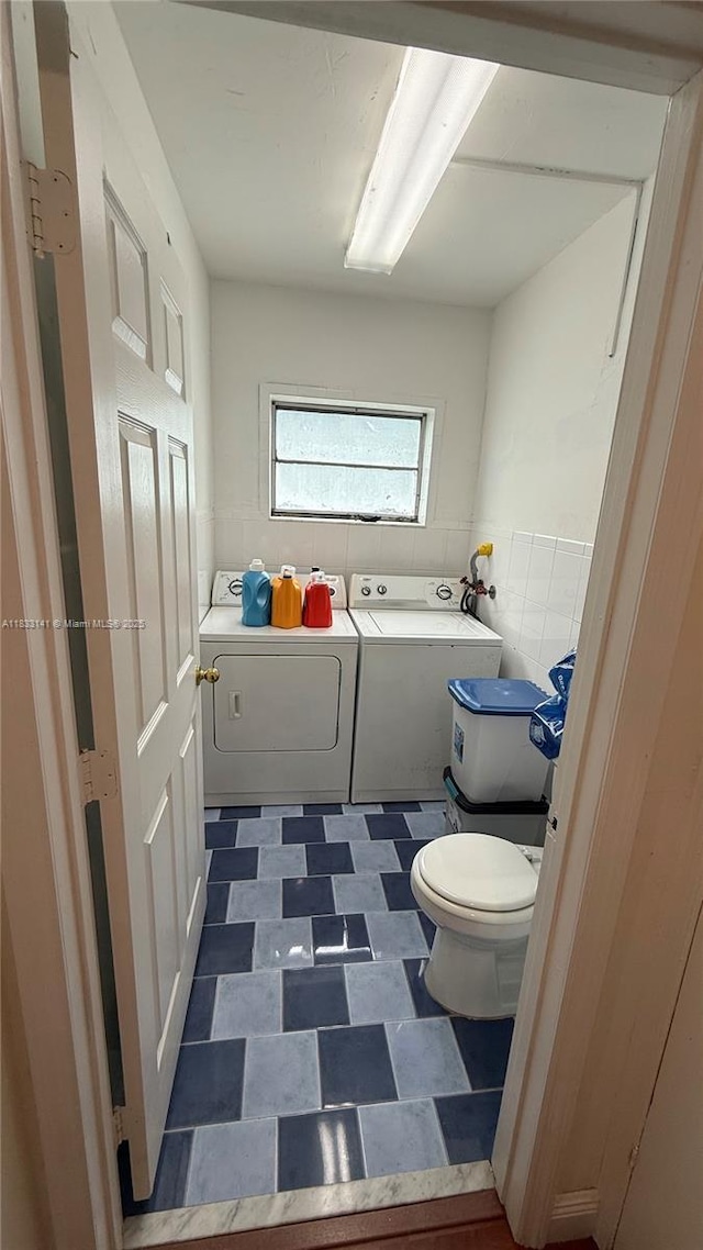 110 SW 64th Ct, Miami, FL 33144 - full bath featuring washer and clothes dryer, a garden tub, tile patterned floors, and tile walls