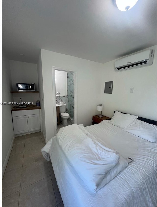 110 SW 64th Ct, Miami, FL 33144 - bedroom featuring a wall mounted AC, light tile patterned floors, and ensuite bath