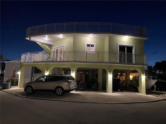65821 Overseas Hwy, Long Key, FL 33001 - view of front of home with a carport, a balcony, driveway, and stucco siding