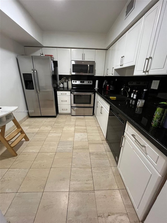 3600 NE Mystic Pointe Dr Unit 1010, Aventura, FL 33180 - kitchen featuring appliances with stainless steel finishes, white cabinets, and dark countertops