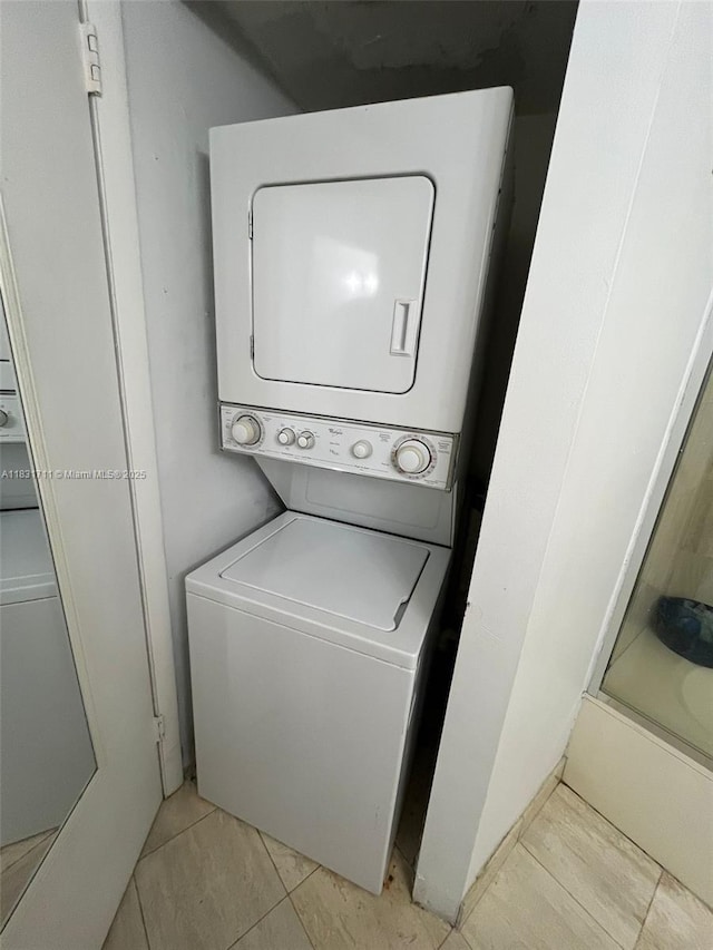 3600 NE Mystic Pointe Dr Unit 1010, Aventura, FL 33180 - laundry room featuring estacked washer and dryer and light tile patterned floors