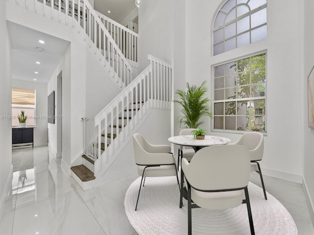 171 NW 152nd Ave, Pembroke Pines, FL 33028 - dining space with marble tiled flooring, stairs, a high ceiling, and recessed lighting