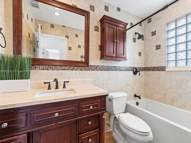 171 NW 152nd Ave, Pembroke Pines, FL 33028 - bathroom featuring tile walls, plenty of natural light, vanity, and tub / shower combination