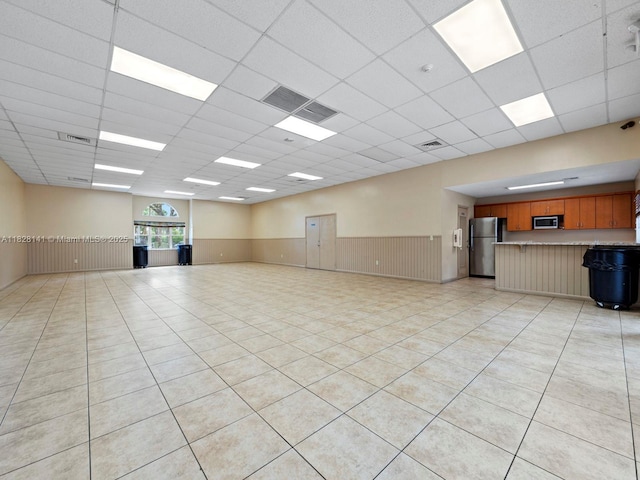 171 NW 152nd Ave, Pembroke Pines, FL 33028 - empty room featuring a paneled ceiling, wainscoting, and light tile patterned floors