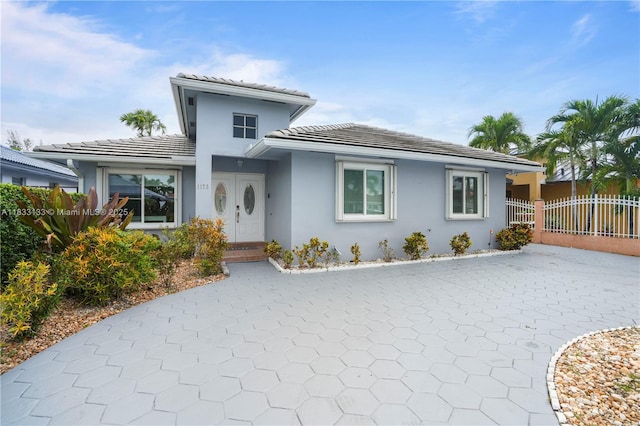 1173 NW 134th Pl, Miami, FL 33182 - view of front of house featuring stucco siding, a tile roof, and decorative driveway