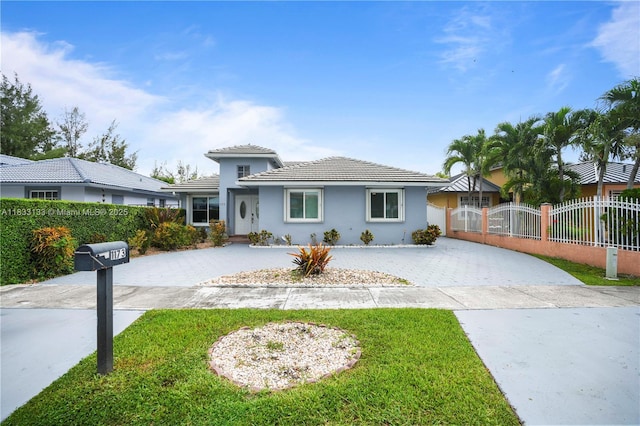 1173 NW 134th Pl, Miami, FL 33182 - view of front facade with decorative driveway, stucco siding, and a tile roof
