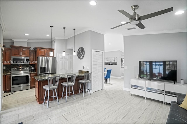 1173 NW 134th Pl, Miami, FL 33182 - kitchen with appliances with stainless steel finishes, a breakfast bar, ceiling fan, a peninsula, and recessed lighting