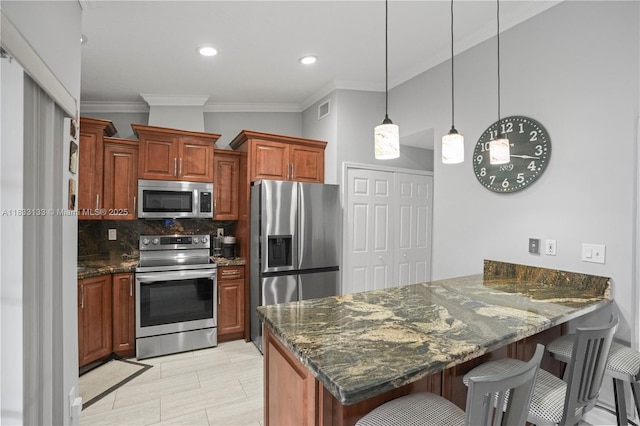 1173 NW 134th Pl, Miami, FL 33182 - kitchen featuring appliances with stainless steel finishes, ornamental molding, a peninsula, a breakfast bar, and tasteful backsplash