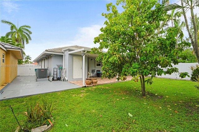 1173 NW 134th Pl, Miami, FL 33182 - rear view of property with a patio, a fenced backyard, stucco siding, and a tile roof