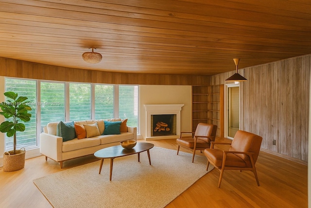 1180 NE 102nd St, Miami Shores, FL 33138 - living area with wood ceiling, wood walls, light wood-style floors, and a fireplace