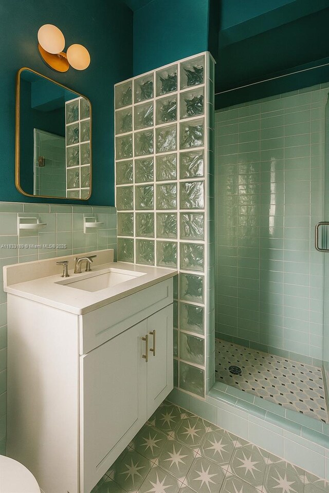 1180 NE 102nd St, Miami Shores, FL 33138 - full bathroom with a shower stall, vanity, tile patterned floors, and tile walls