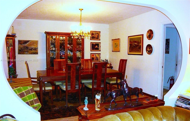 17123 SW 78th Pl, Palmetto Bay, FL 33157 - dining space featuring arched walkways and a chandelier